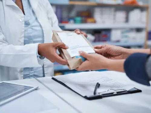 Pharmacist helping a customer.
